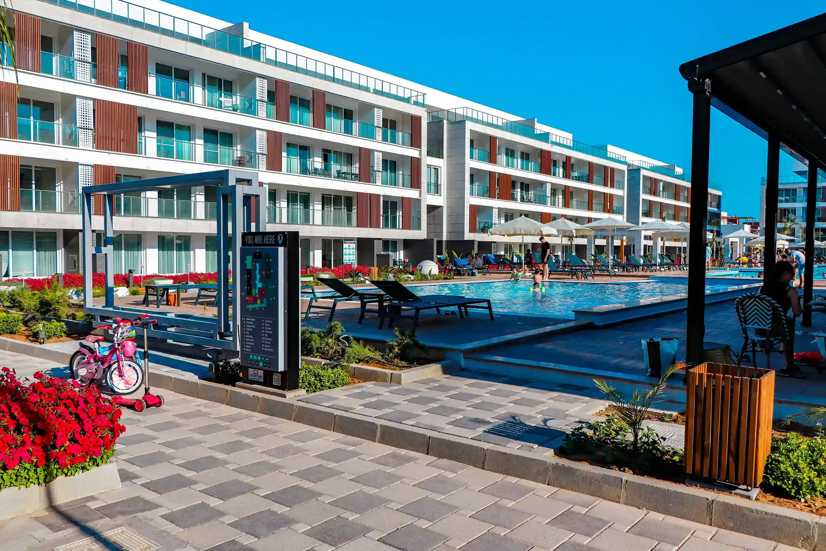 The iconic completed swimming pools and Mediterranean gardens of Courtyard Long Beach by Döveç Group, a benchmark for luxury living in North Cyprus.